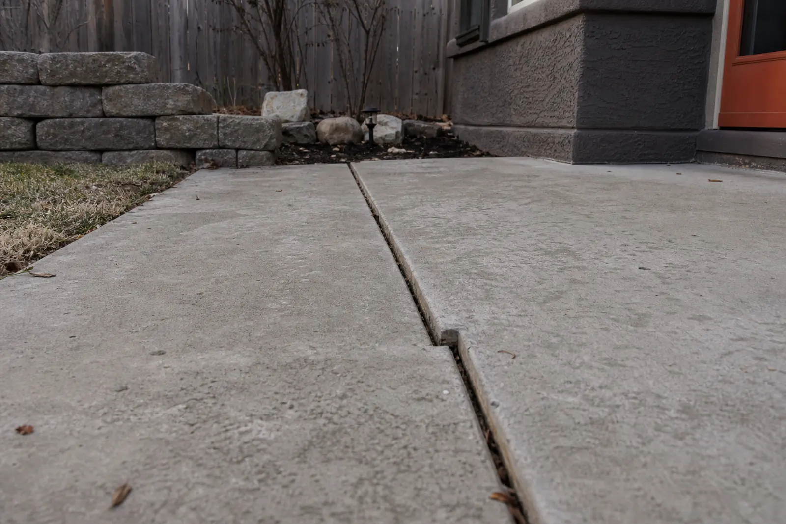 Cracked concrete walkway with the two pieces at slightly different heights