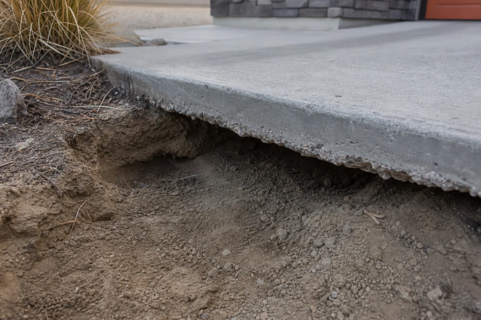 Soil eroded away beneath the edge of a concrete slab